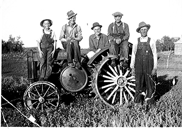 My dad and grandfather with local farmers in front of the old steel wheeled John Deere Model "D" tractor in rural Alberta.